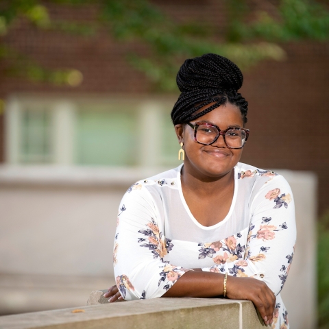 Portrait of Allure Cooper '23 leaning on wall