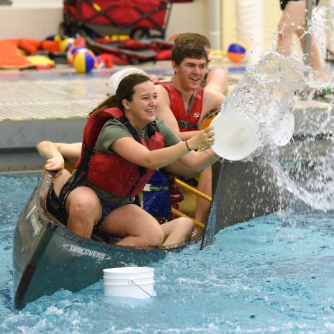 Students in the pool playing canoe battleship