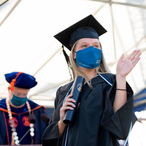 Student with diploma during Commencement 2021
