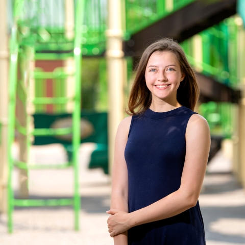 Brooke Ewer stands outside on a playground.