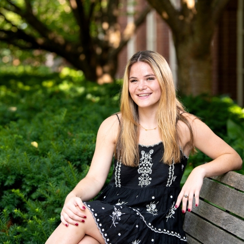 Portrait of student Hannah Sieg sitting on a bench