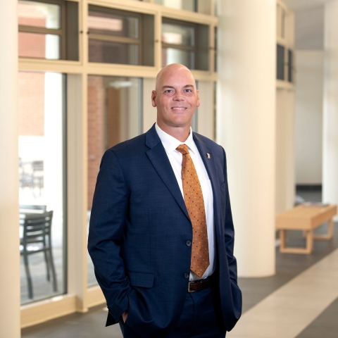 Portrait of Brad Putman in a suit inside Academic East