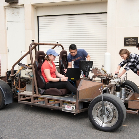 Mechanical engineering students work on car