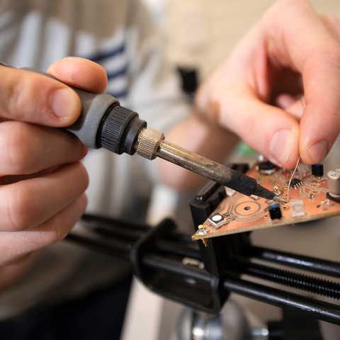Student working of firefly circuit board