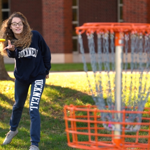 Student playing disc golf