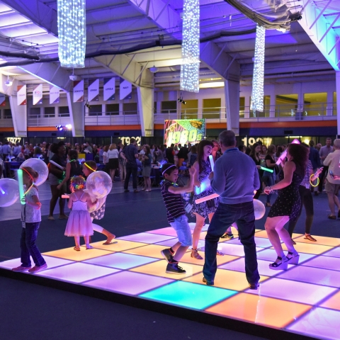 People dancing on a light up dance floor