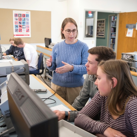 Professors with students in engineering lab