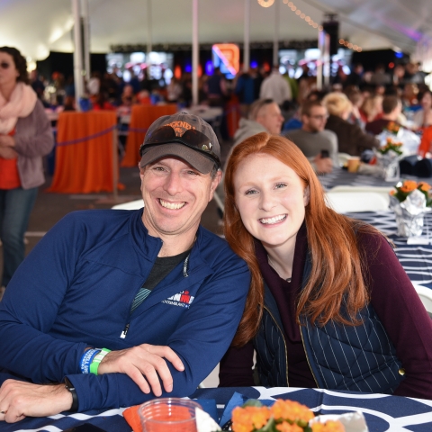 Two students smiling at the tailgate