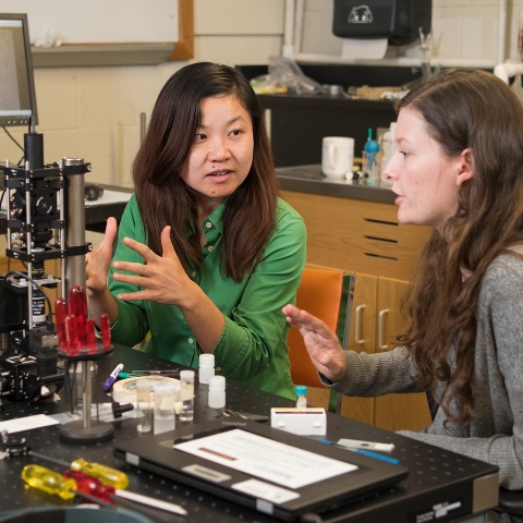 Student and faculty with optical tweezer