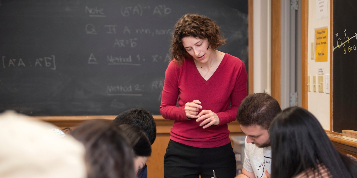 Professor Emily Dryden helping a group of students