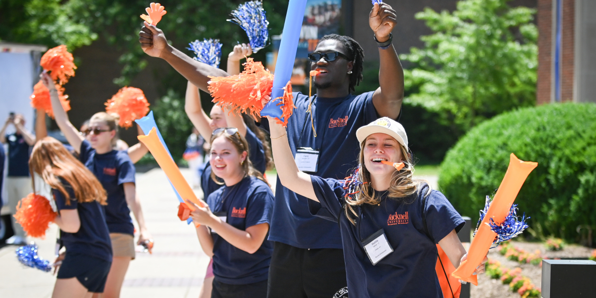 Reunion Ambassadors wave pom-poms and cheer.
