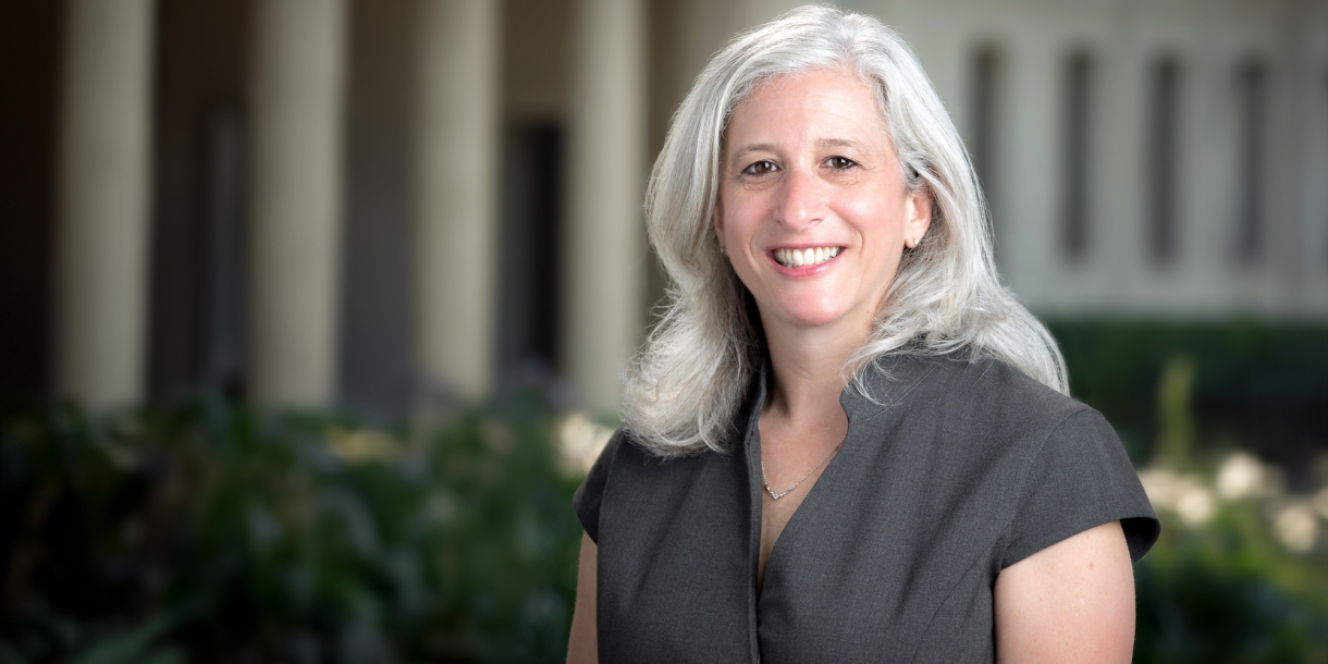 Portrait of Wendy Sternberg from the waist up. She is wearing a gray blouse.