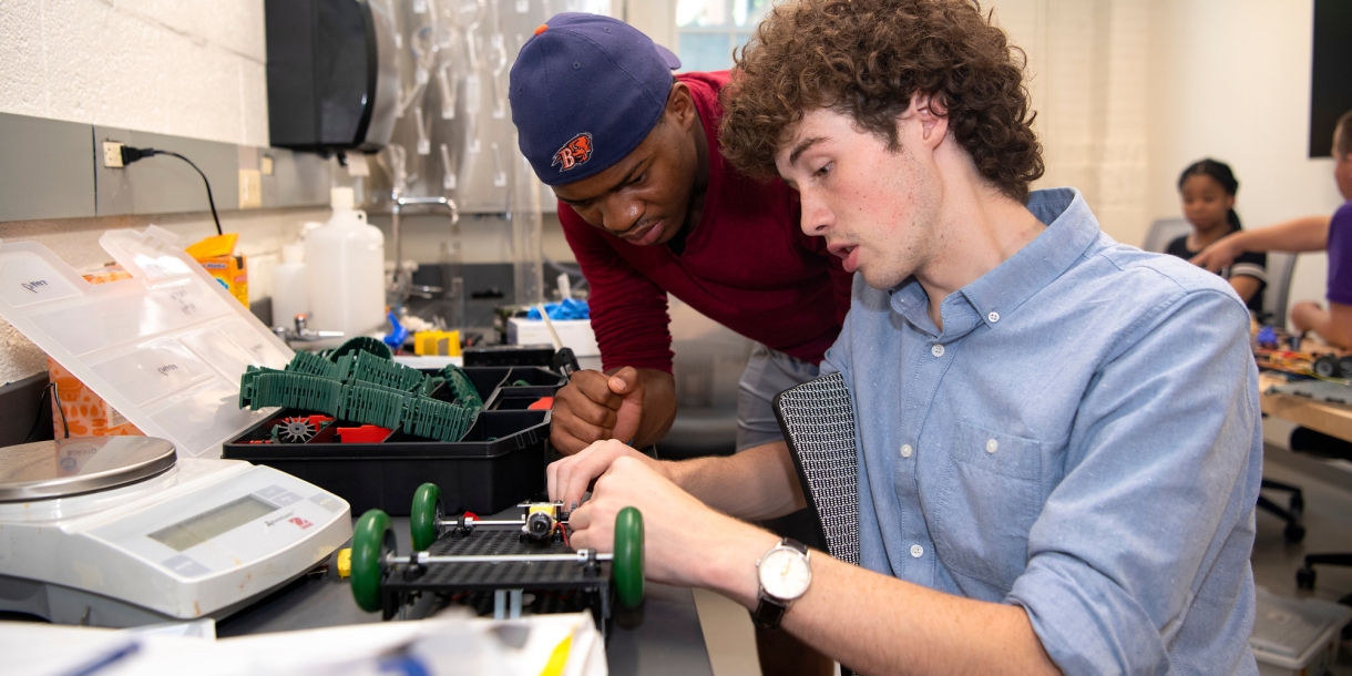 Engineering students working on a car.