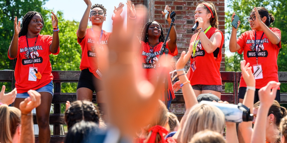 Students karaoke at Hall Olympics during Orientation