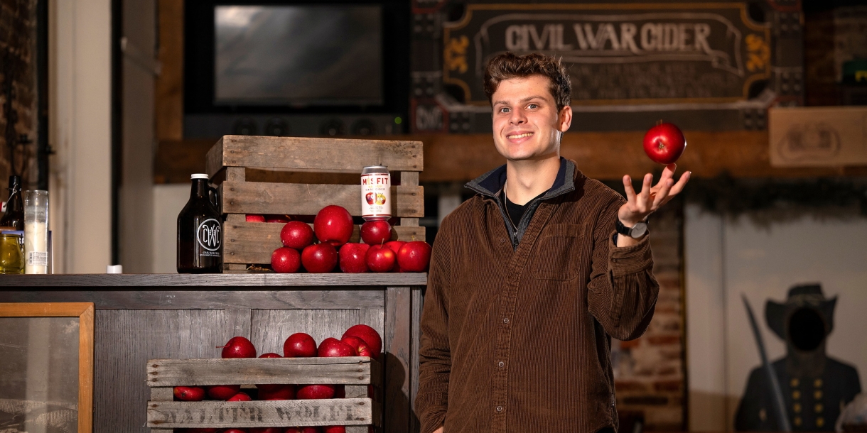 Ben Fink tosses an apple in his right hand at Civil War Cider.