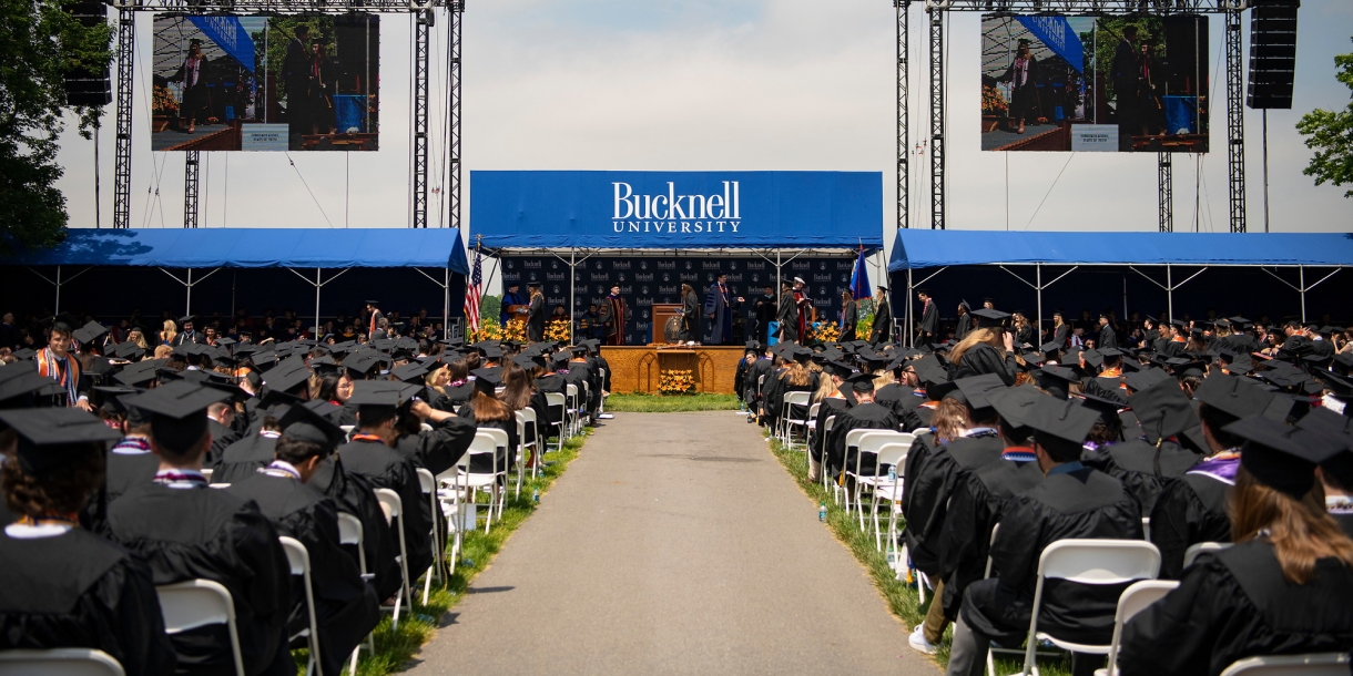 Wide shot of Class of 2019 graduates and the commencement stage on Malesardi Quad