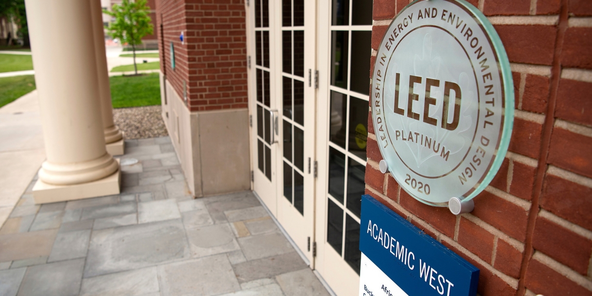 A plaque near the doorway into Academic West that reads LEED Platinum 2020