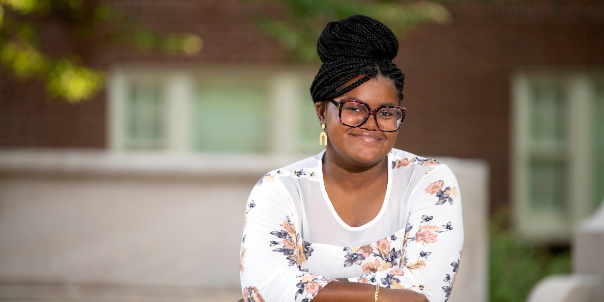 Portrait of Allure Cooper &#039;23 leaning on wall