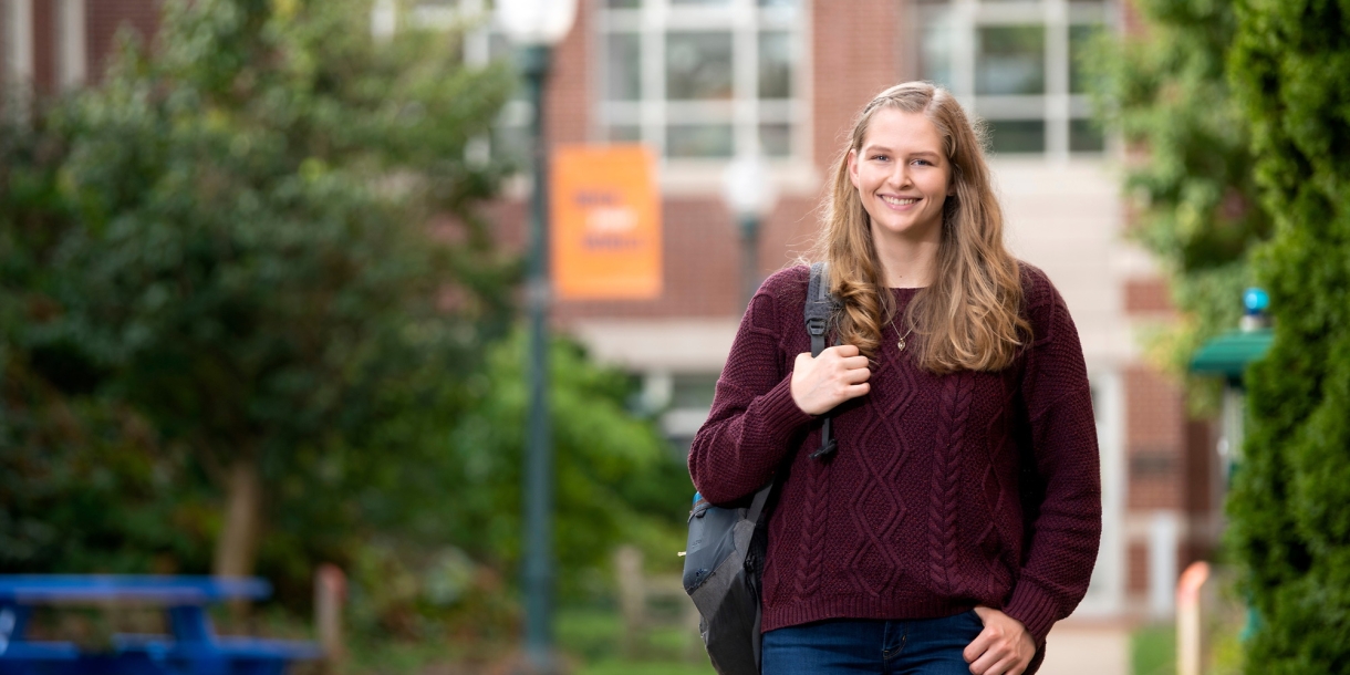 Emily Scholfield walks on campus