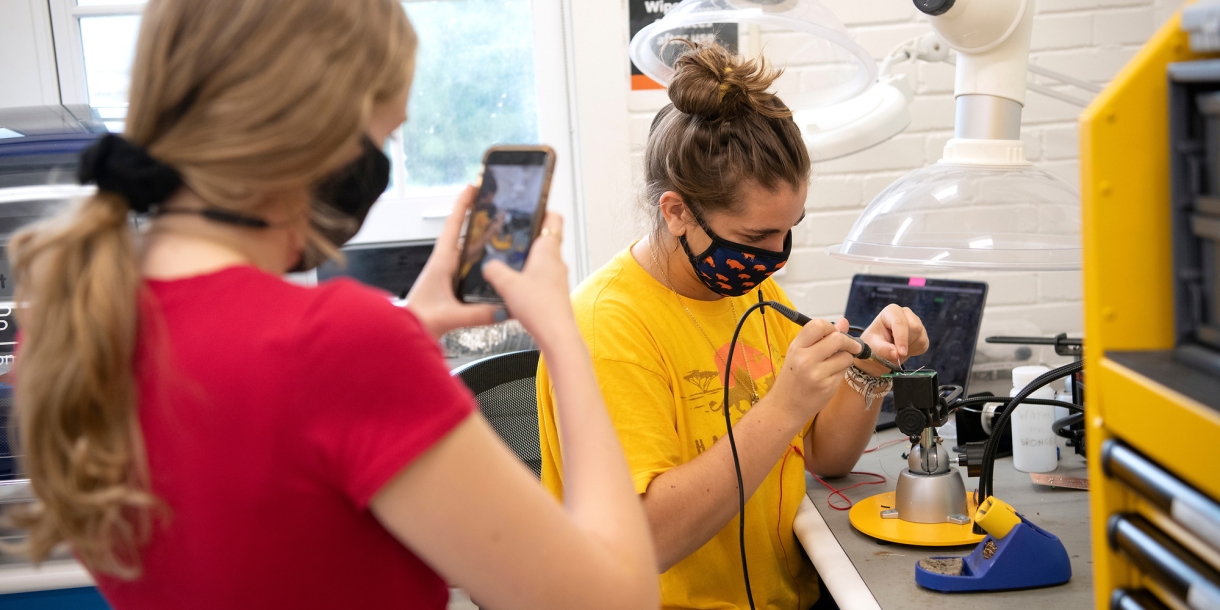 Computer engineering majors Rachel Cherrey '22 and Daniela Bellini '22 build circuit boards inside the Maker-E, Bucknell's electrical & computer engineering makerspace