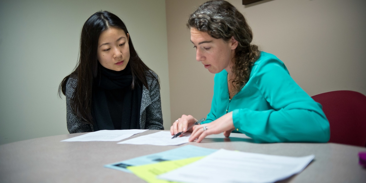 Megan Wolleben and a student go over a résumé.