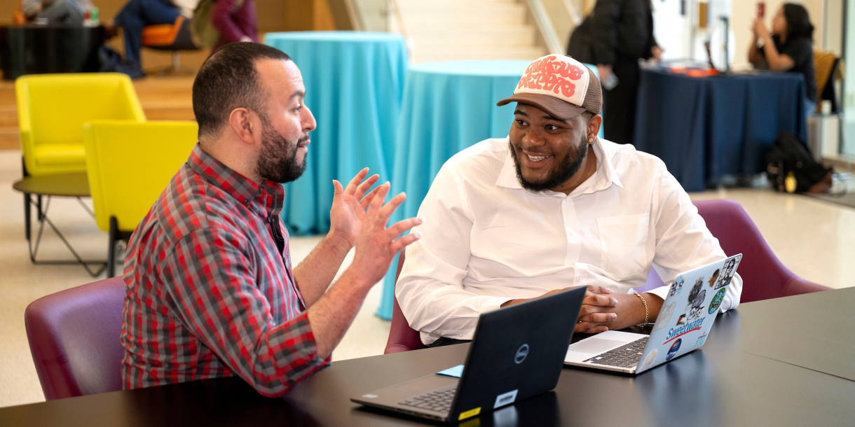 Tony Gomez and Kenneth Scott Jr. sit in Holmes Hall and talk