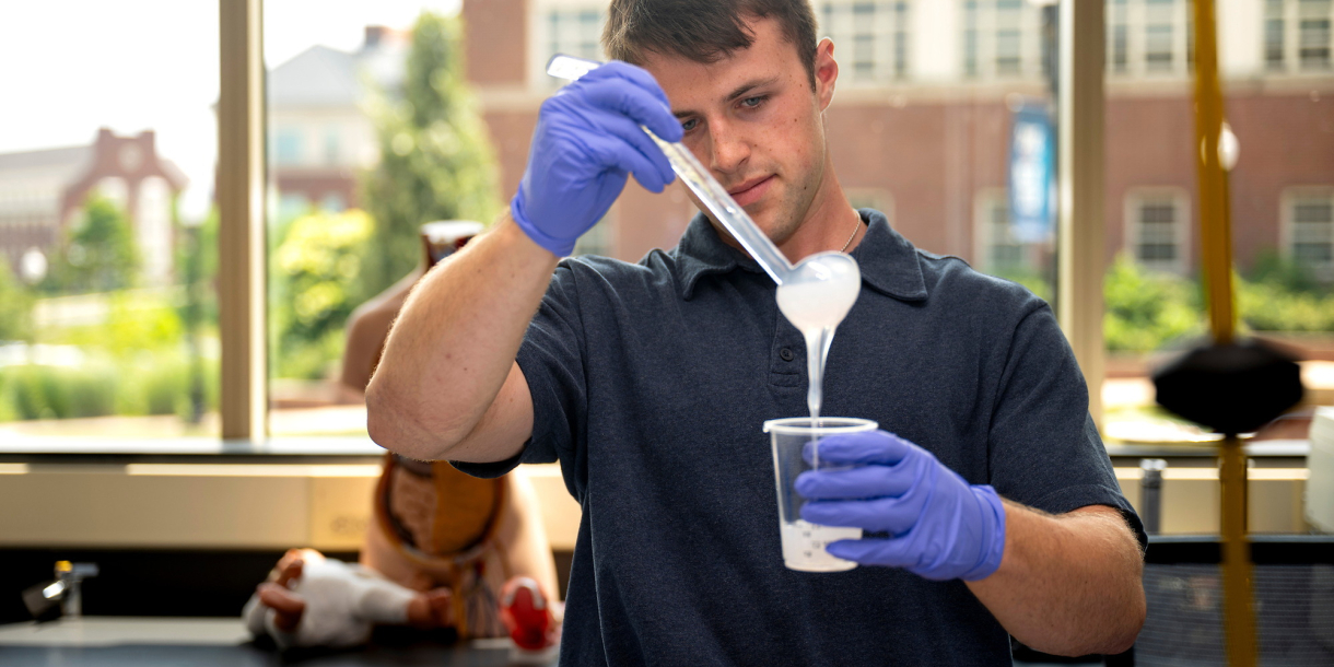 Tanner Tighelaar pours silicon into a mold