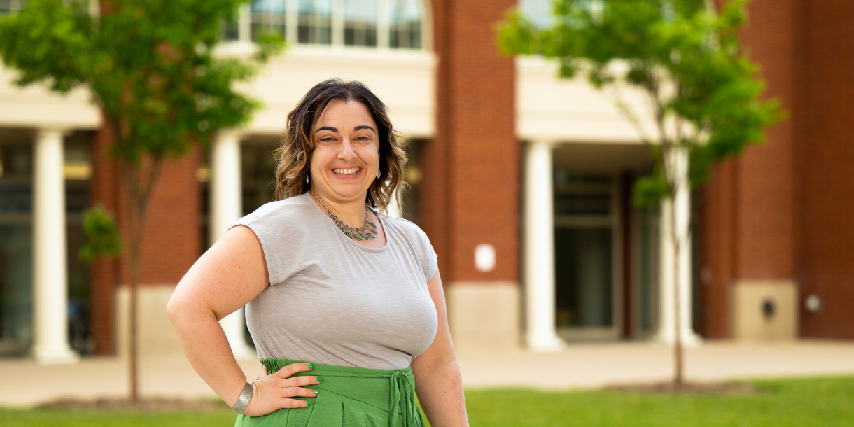 Vanessa Massaro stands outside with one hand on her hip