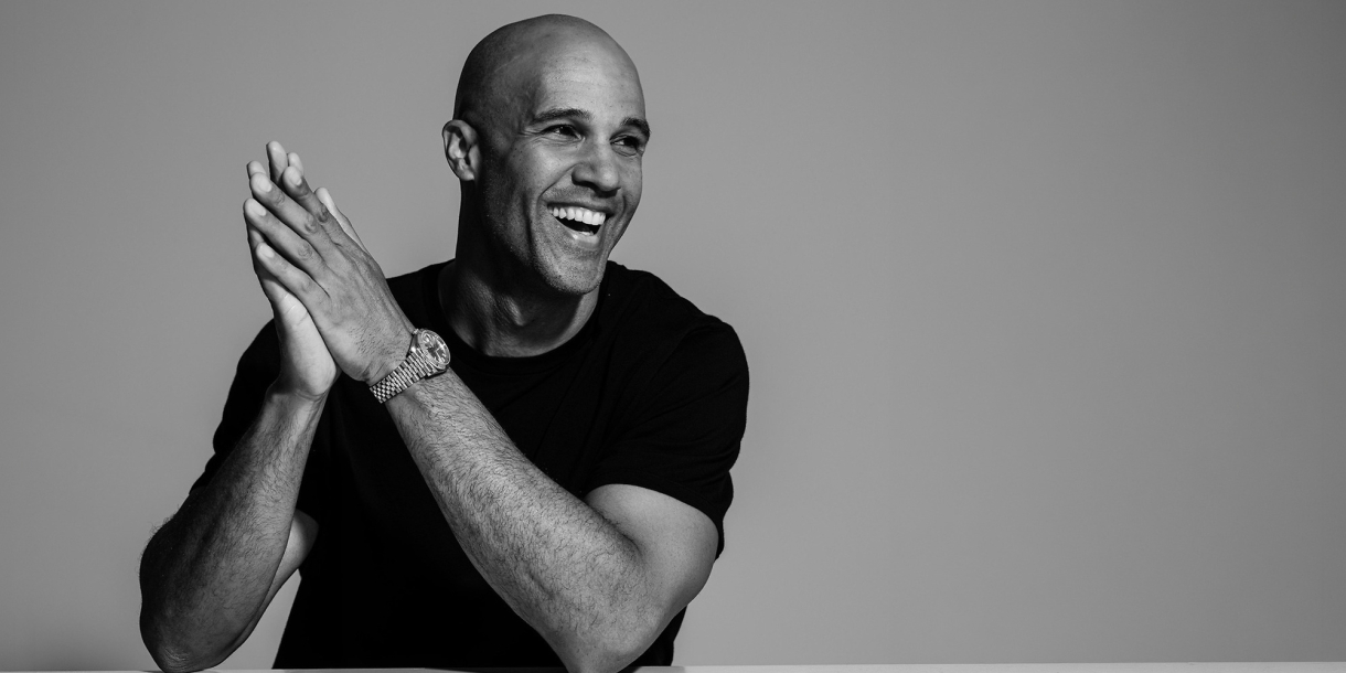 Mark Tallman smiles in this black and white image.