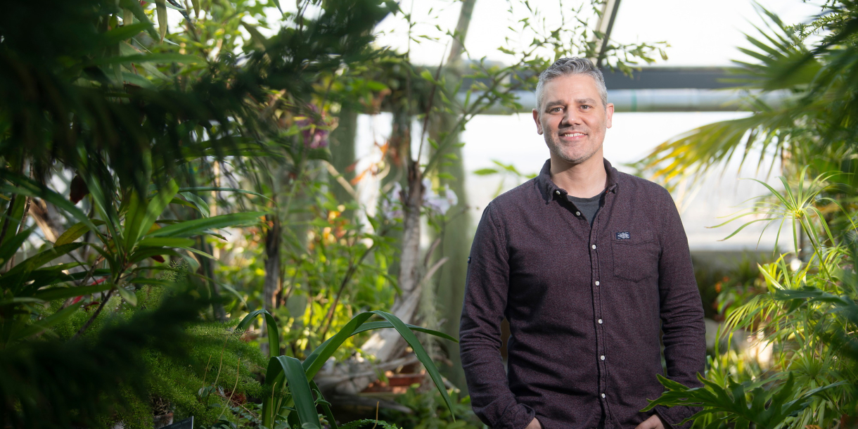 Portrait of Professor Mark Haussmann inside the Rooke Science Greenhouse