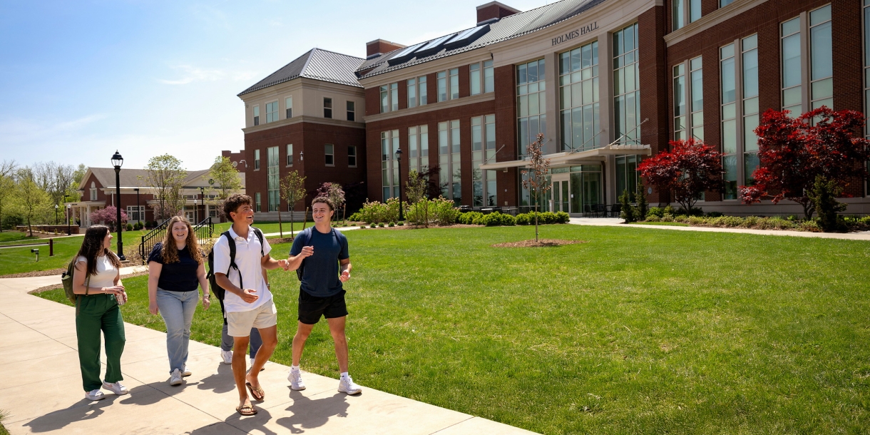 Students walk in front of Holmes Hall