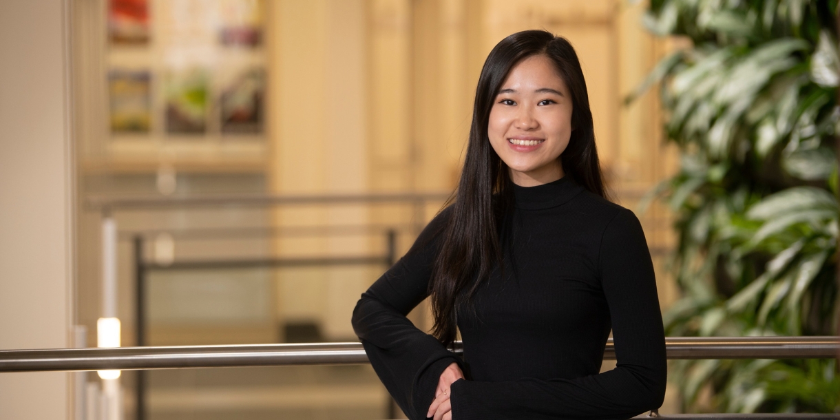 Wutt Kyi '22 poses against indoor railing