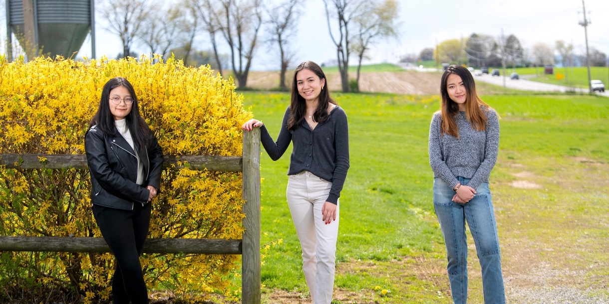 Student researchers pose at farm