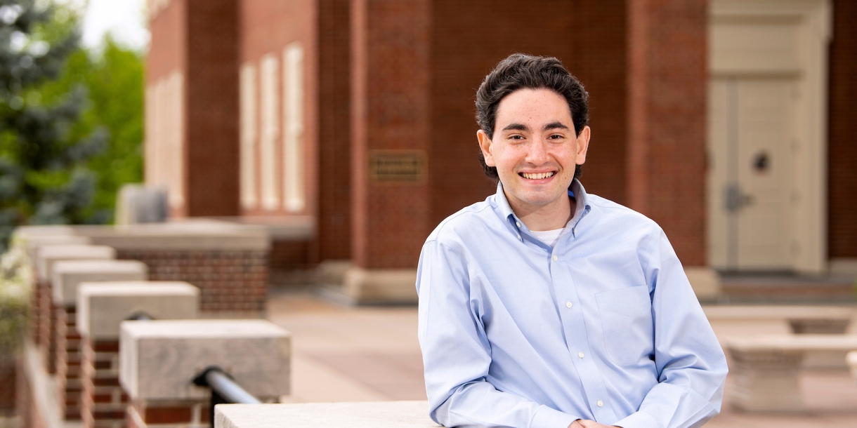 Gabe Gross leans on a railing on Malesardi Quad outside Marts Hall.