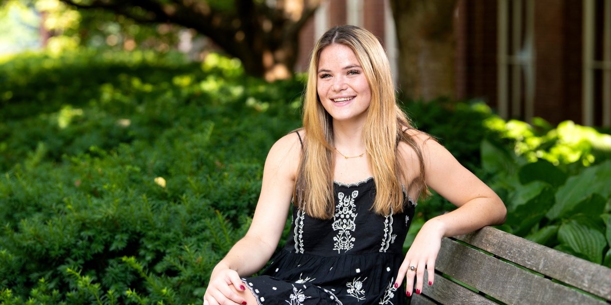 Portrait of student Hannah Sieg sitting on a bench