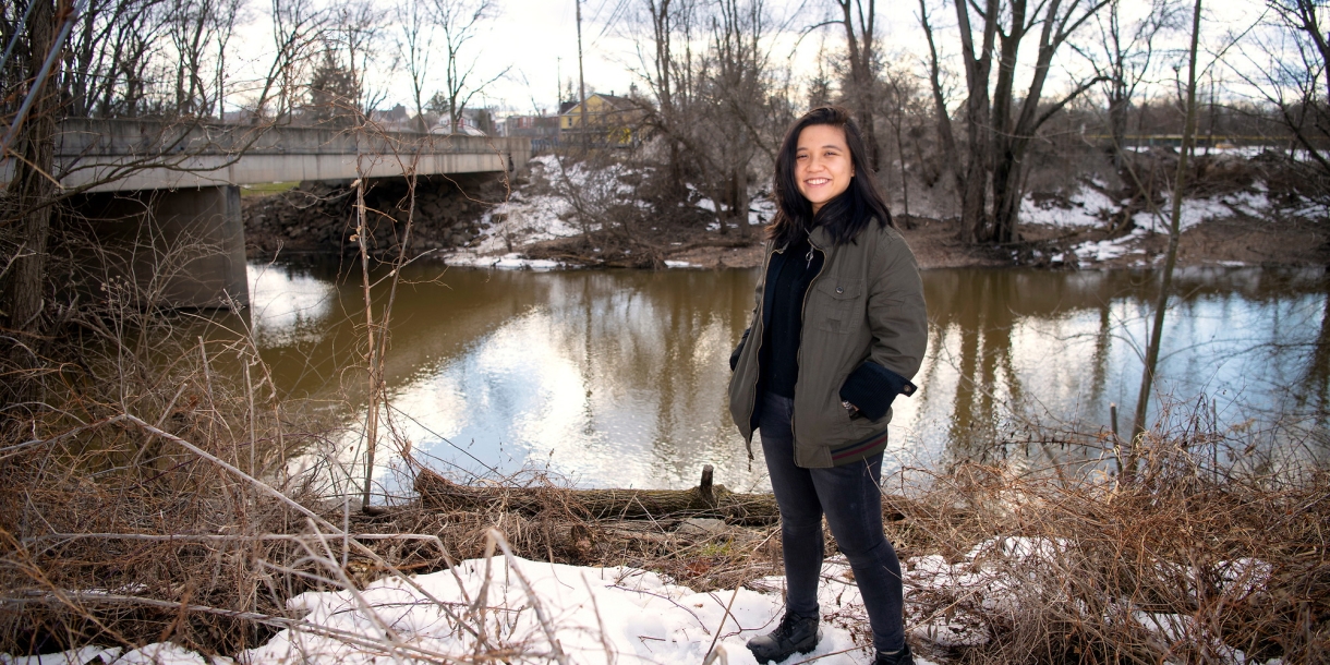 Lam Ngo ’22 stands by a tributary of the Susquehanna River in Lewisburg in winter