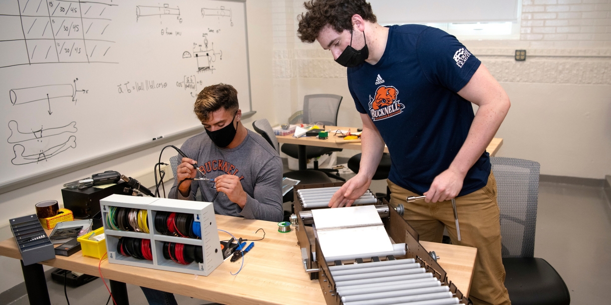 Mechanical engineering majors Michael Bortolot '21 and Nate Romanowski '21 assemble their prototype sanitizing device
