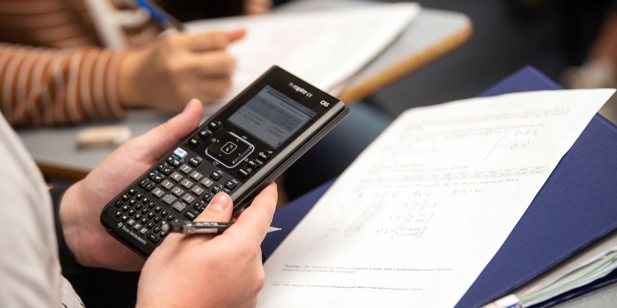 Student holding calculator