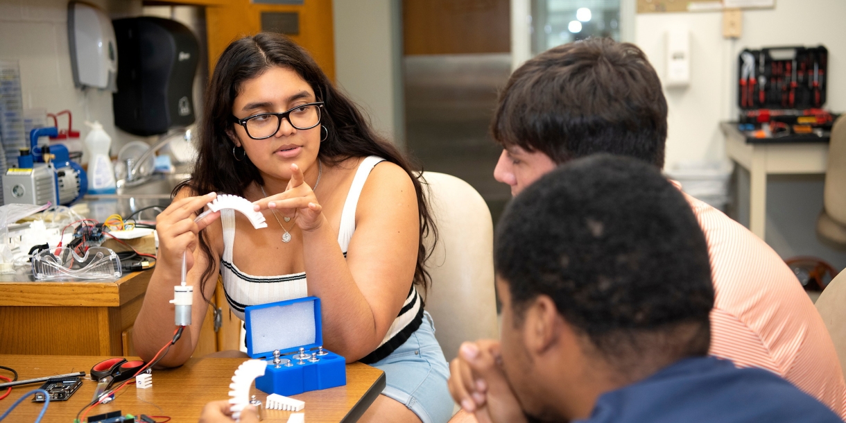 Student displays a 3D-printed spine to collaborators
