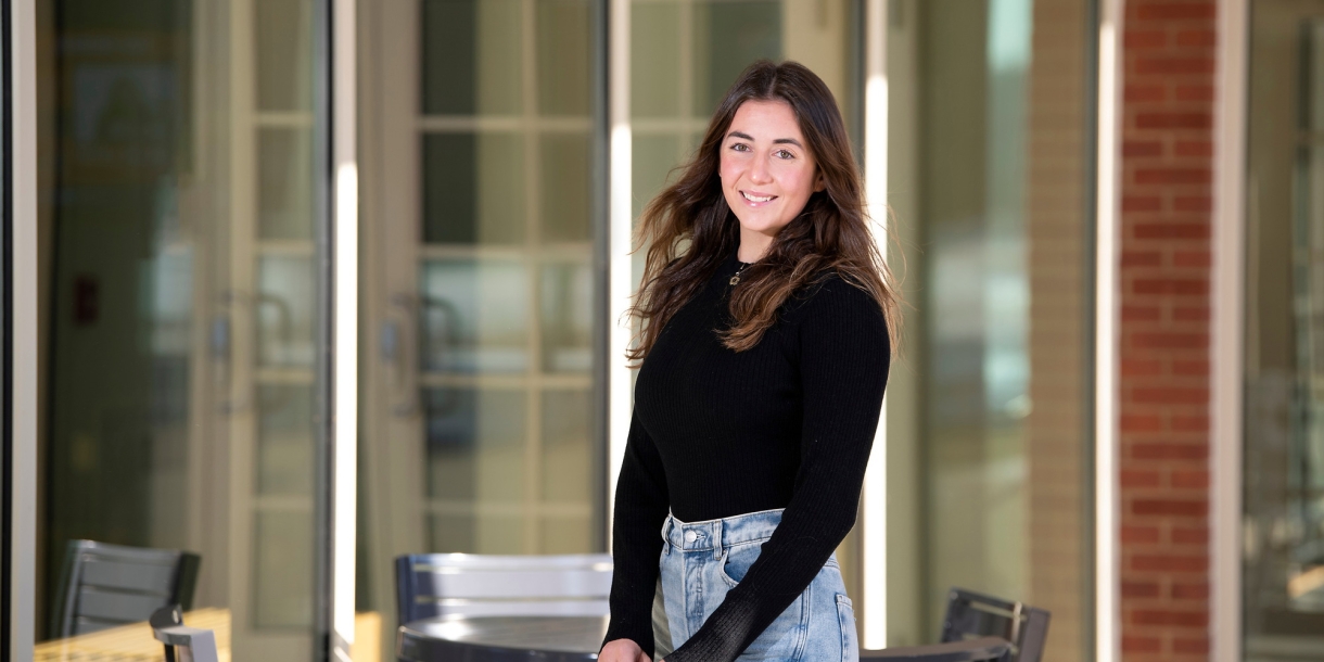 A student stands outside a building on Bucknell&#039;s campus