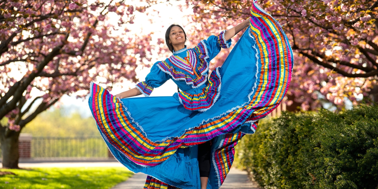 Gabby Diaz' dances folklorico among blossoming cherry trees
