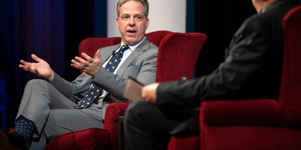 Jake Tapper speaks on stage at the Bucknell Forum