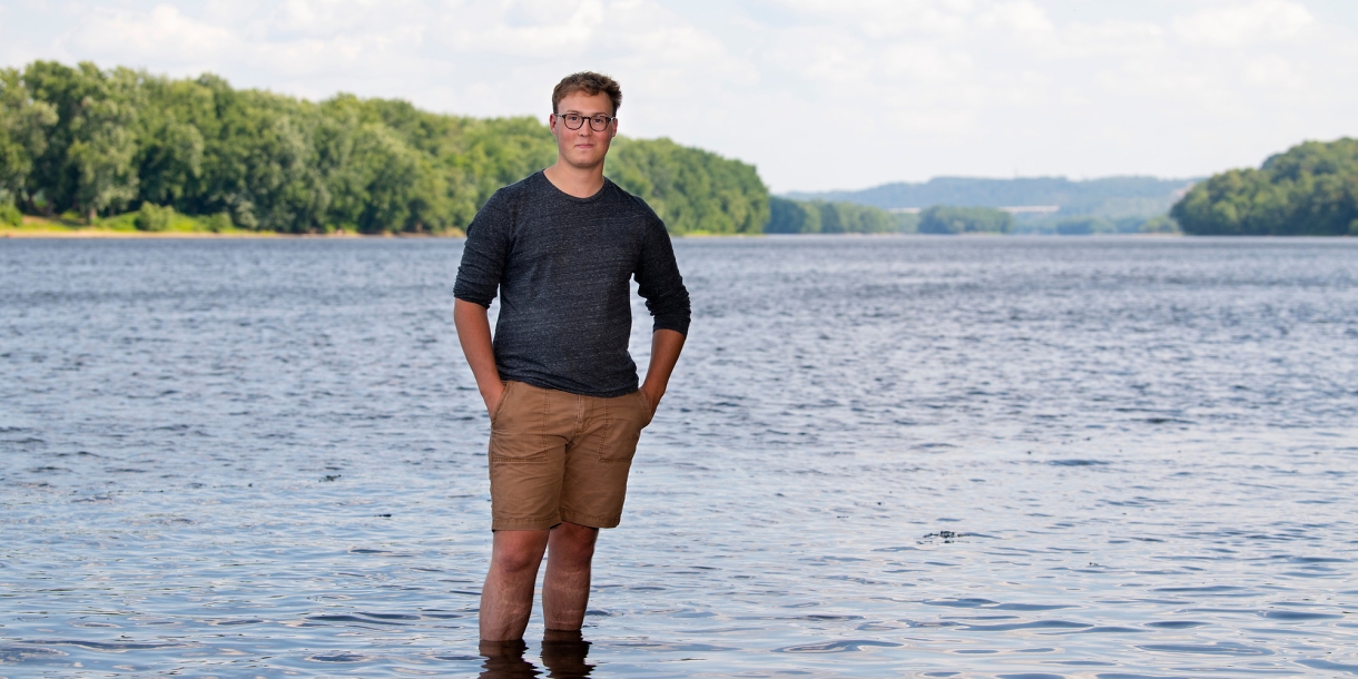 Kit Jackson stands ankle deep in the Susquehanna River