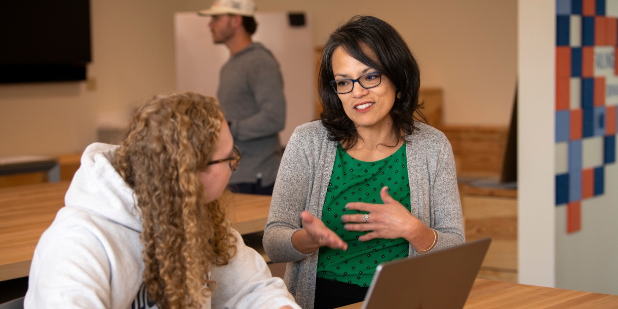 Professor Gabriela Diego with a student in a MIDE class