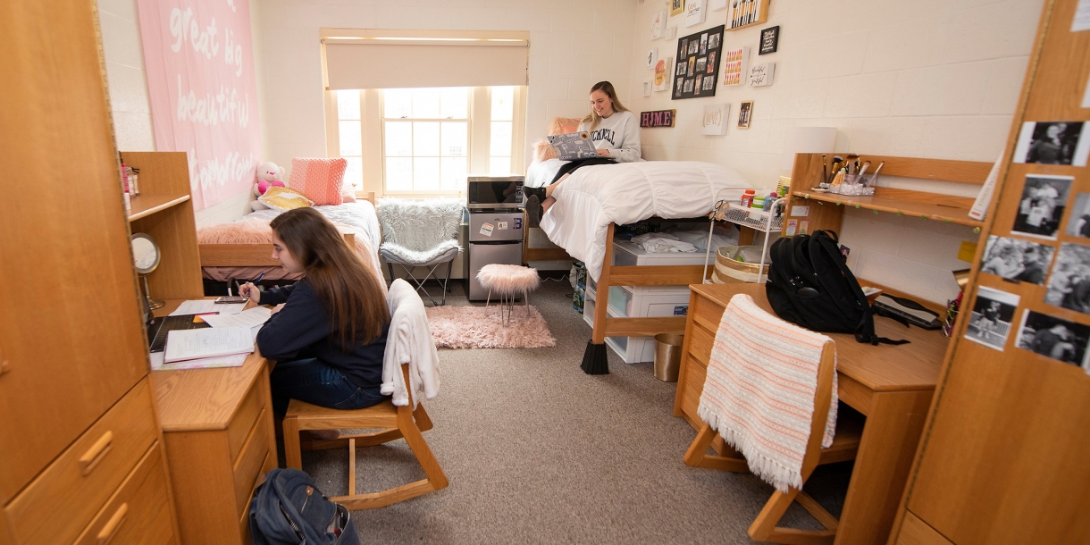 Two students studying in their decorated dorm room at Bucknell University