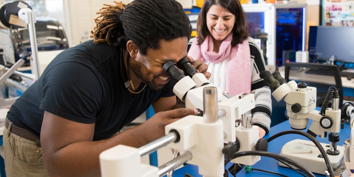 Student looks into a microscope