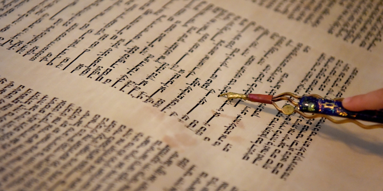 A close up of the Torah being read