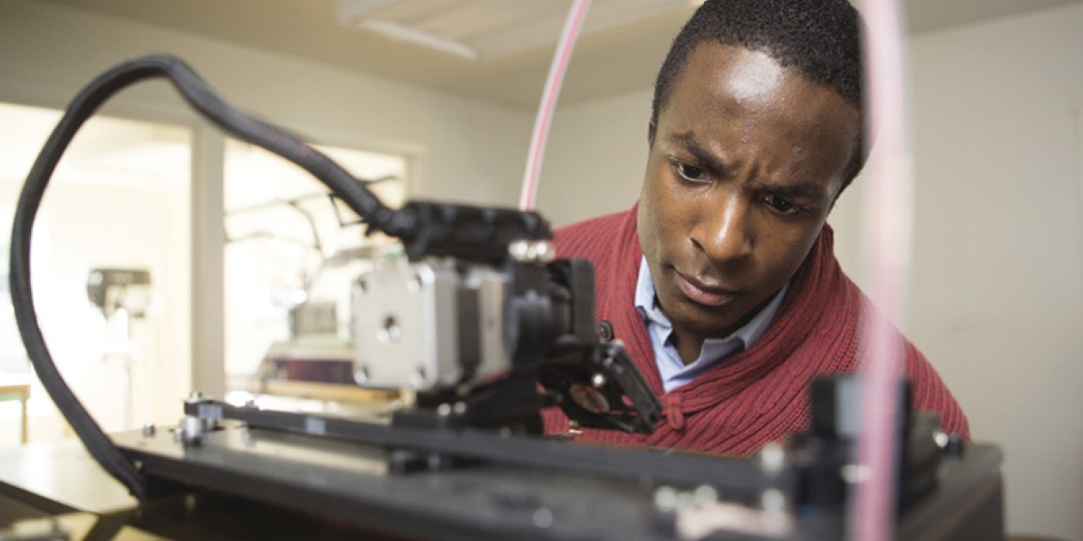 Person working at a 3D printer