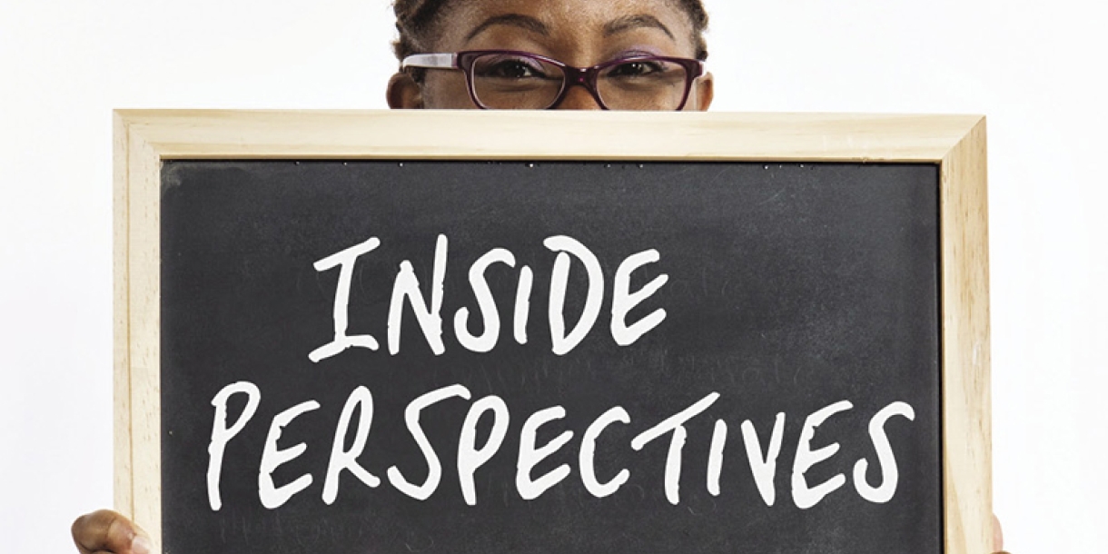 Person holding up chalkboard saying inside perspectives