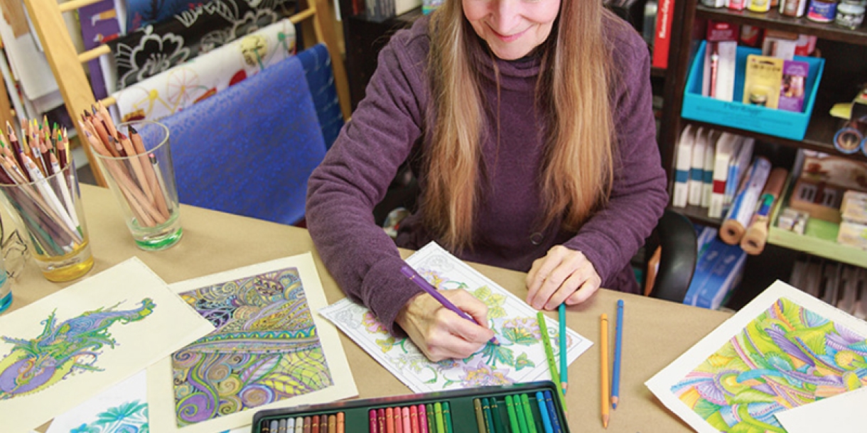 Artwork and supplies laid out across a table